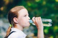 Girl drinking water outdoors Royalty Free Stock Photo