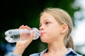 Girl drinking water outdoors Royalty Free Stock Photo