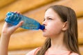 Girl drinking water outdoors Royalty Free Stock Photo