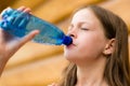 Girl drinking water outdoors - very shallow depth of field Royalty Free Stock Photo