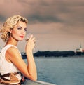 Girl drinks champagne near the river