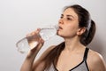 Girl drinks clear water. Weight loss through compliance with the water regime.