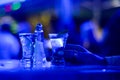 Girl drinks shot of tequila. Limes, salt and shots on table in nightclub. Hand of girl holding glass of alcohol drink in pub. Lady