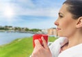 Girl drinks tea on a background sea landscape. Royalty Free Stock Photo