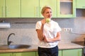 Girl drinks tea in the morning in a cozy kitchen at home. good day Royalty Free Stock Photo