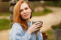 Girl drinks tea in morning in yard near stone well of village house in Provence Royalty Free Stock Photo