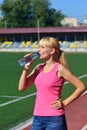 The girl drinks water at the stadium Royalty Free Stock Photo