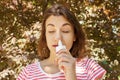 Girl drips blocked nose from allergy. Woman with Respiratory Spray for nose in Spring Blooming. Portrait of a woman having respira Royalty Free Stock Photo