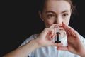 The girl drips into her nose with a spray of cold