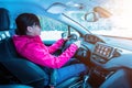 Girl drives a modern SUV car. The concept of a winter vacation trip to the mountains