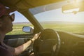 Girl driving on the autobahn, moving towards the sun in a mountainous area, the problem of poor visibility of the road