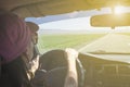 Girl driving on the autobahn, moving towards the sun in a mountainous area, the problem of poor visibility of the road Royalty Free Stock Photo