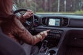 Girl driving car, presses emergency stop button, turns on security, signal is off, accident on road, warn danger on road Royalty Free Stock Photo