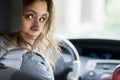 Girl driving car. Young woman behind driver`s seat looking at car`s rear seat. Royalty Free Stock Photo