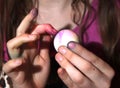 Girl dying Easter eggs and her fingers