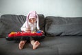 girl in an Easter bunny costume with cap with hare ears plays on a children& x27;s synthesizer. Teaching children& x27;s music Royalty Free Stock Photo