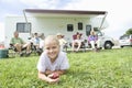 Girl Eating Apple With Family Sitting Outside RV Home