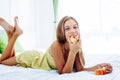 Girl eating apple and relaxing in bedroom Royalty Free Stock Photo