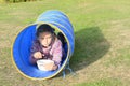 Girl eating in blue kids tunnel Royalty Free Stock Photo