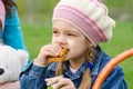 Girl eating cake at a picnic
