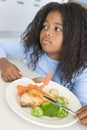Girl eating chicken and vegetable dinner at home Royalty Free Stock Photo