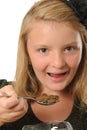 Girl eating coins Royalty Free Stock Photo