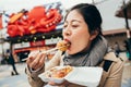 Girl eating delicious octopus balls Royalty Free Stock Photo