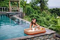 Girl eating floating breakfast in luxury infinity pool Royalty Free Stock Photo
