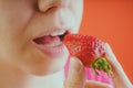 Girl eating fresh strawberries, close-up Royalty Free Stock Photo