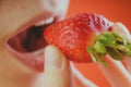 Girl eating fresh strawberries, close-up Royalty Free Stock Photo