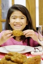 Girl eating fried chicken drumstick Royalty Free Stock Photo