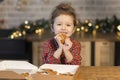 Girl eating gingerbread man cookie for new year.  child eating christmas cookies Royalty Free Stock Photo
