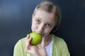 Girl eating a green apple Royalty Free Stock Photo