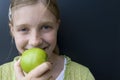 Girl eating a green apple Royalty Free Stock Photo