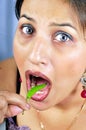 Girl eating green chilly Royalty Free Stock Photo