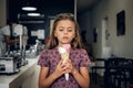 A girl eating ice cream in a cafe. Royalty Free Stock Photo