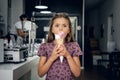 A girl eating ice cream in a cafe. Royalty Free Stock Photo