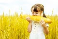 Girl eating a long loaf Royalty Free Stock Photo