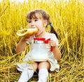 Girl eating a long loaf Royalty Free Stock Photo