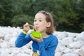 Girl eating in nature, having picnic with her family. Outdoor lifestyle, positive parenting, childhood experience concept