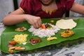 Girl eating Onam Sadhya with hand form Kerala India