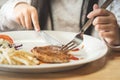 Girl eating pork steak with Vegetables Royalty Free Stock Photo