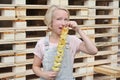 Girl eating potato chips on a stick. Junk food, street food, snack on a walk.