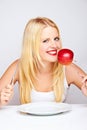 Girl eating an red apple with a fork Royalty Free Stock Photo