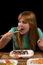 Girl eating rolls at the table