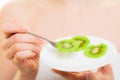 Girl eating slices of kiwi fruit. Healthy diet. Royalty Free Stock Photo