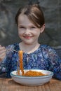 Girl is eating spaghetti