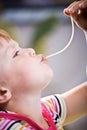 Girl eating spaghetti