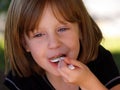 Girl eating spoonful Royalty Free Stock Photo