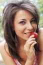 Girl eating a strawberry